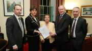 Eileen Evason (centre) with members of her team that produced the WR mitigation report as well as the First and deputy First Minister