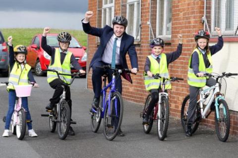 Chris Hazzard MLA, then Minister for Infrastructure, with pupils from St Colmcille's Primary School in Downpatrick on Bike to School Day in June 2016
