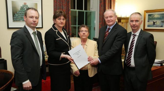 Prof. Eileen Evason (centre) along with Barry McVeigh (left) and Kevin Higgins (right), both members of her team that produced the Welfare Reform mitigation report, and the then First and deputy First Ministers