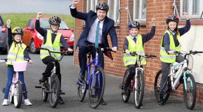 Chris Hazzard MLA, then Minister for Infrastructure, with pupils from St Colmcille's Primary School in Downpatrick on Bike to School Day in June 2016